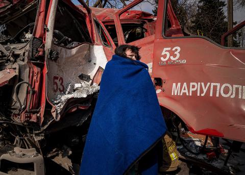 Eine Frau vor einem zerstörten Feuerwehrfahrzeug, Mariupol, 12. März